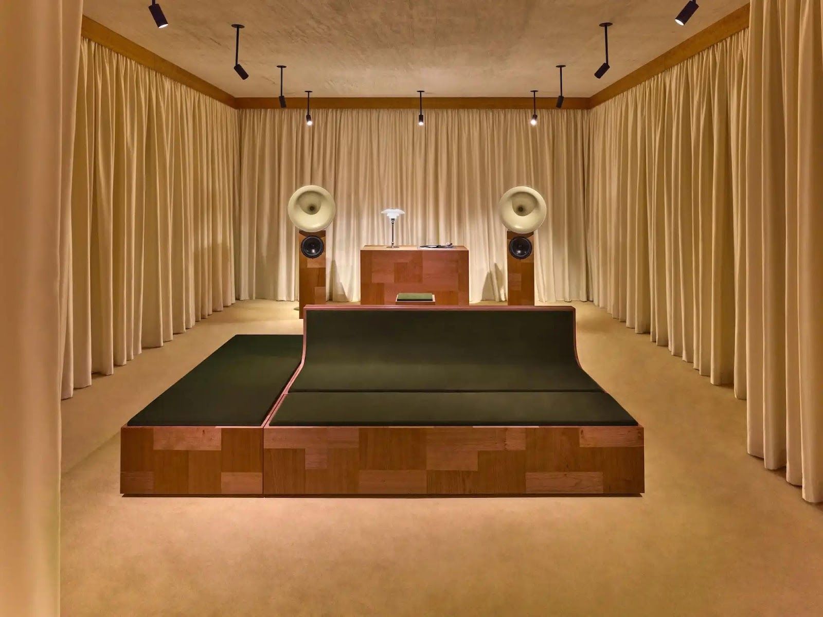 image of L'Atelier Sonore, a new listening room by Valentino opening on May 15 at their Madison Avenue boutique in New York. Created in collaboration with Italian collective Terraforma and sound designer Giorgio Di Salvo, the space features a custom audio system, handcrafted wooden furnishings, and velvet seating designed by architect Francesco Lupia. The opening includes a 10-hour program with performances by international artists. The space embodies Creative Director Alessandro Michele's vision for deep listening experiences that connect sound, materials, and human interaction.