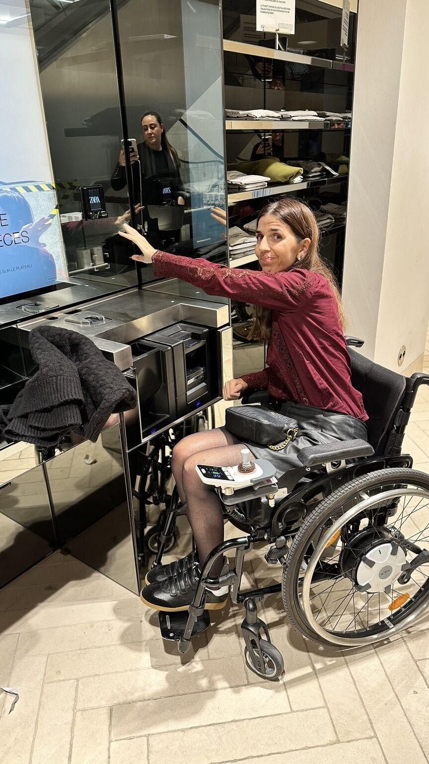 A person in a wheelchair pointing at a televisionAI-generated content may be incorrect.