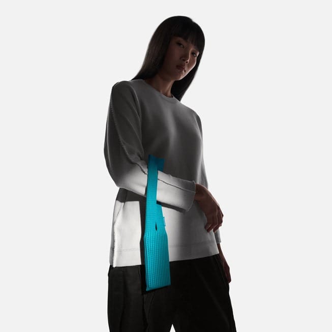 A user poses with iPhone Pocket in peacock.